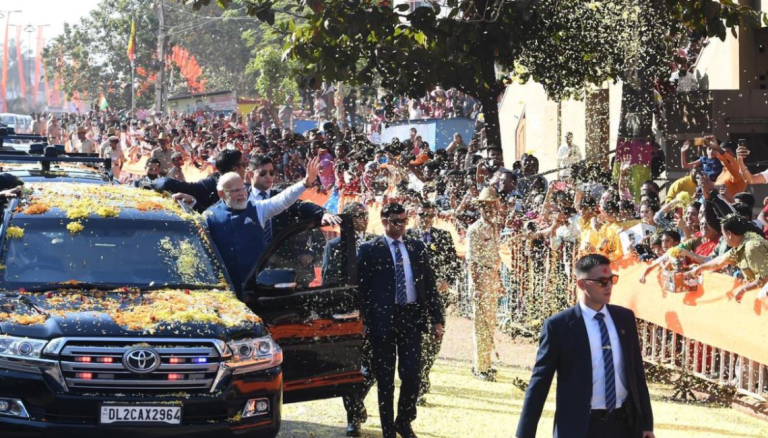 Standing behind barriers, Karnataka BJP leaders greet Modi