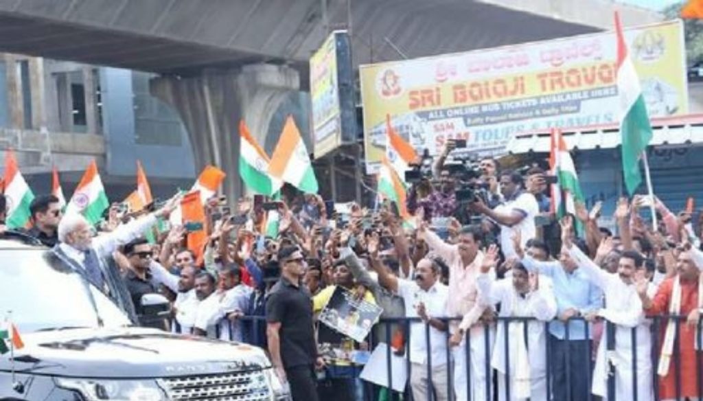 Standing behind barriers, Karnataka BJP leaders greet Modi