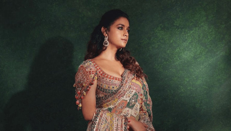Keerthy Suresh radiates majestic grace in her opulent saree attire.