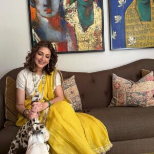 a woman sitting on a couch with a stuffed animal